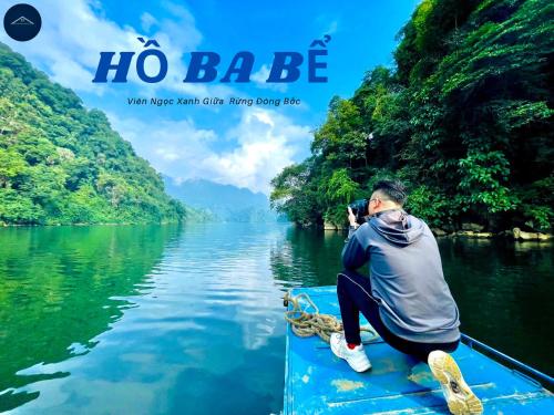 a man taking a picture in a boat on a river at Ba Be Lake View Homestay in An Ma