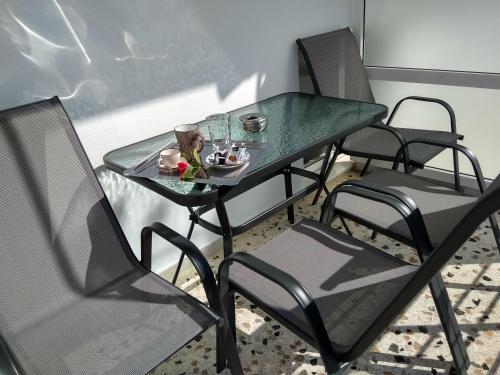 a green table with chairs and a plate of food on it at 3SSS Bouquet Studios SERENITY in Marmarion