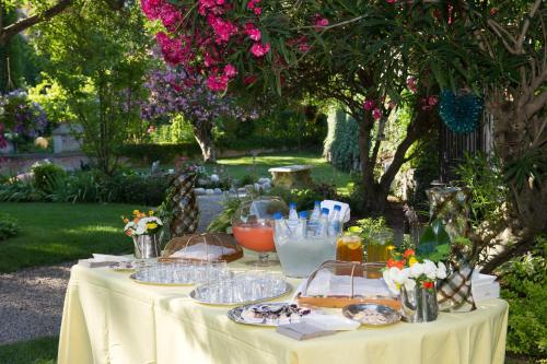 a table with plates of food on it in a garden at B&B Villa Ines in Venice-Lido