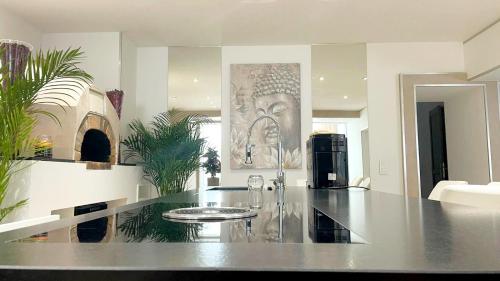 a kitchen with a table with wine glasses on it at Appartement en bord de lac avec jaccuzi in Publier