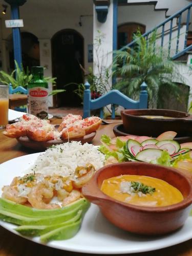 a plate of food with shrimp and rice on a table at Hotel Doña Esther in Otavalo