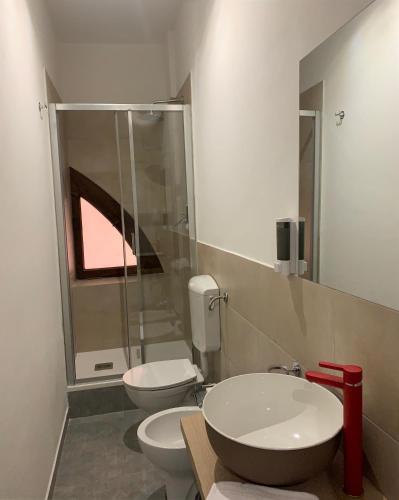 a bathroom with two toilets and a sink and a shower at GALLERIA DEL TORO 3 rooms in Bologna
