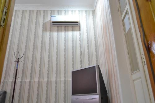 a tv sitting in a room with a curtain at HOSTEL NABI BOBO in Samarkand