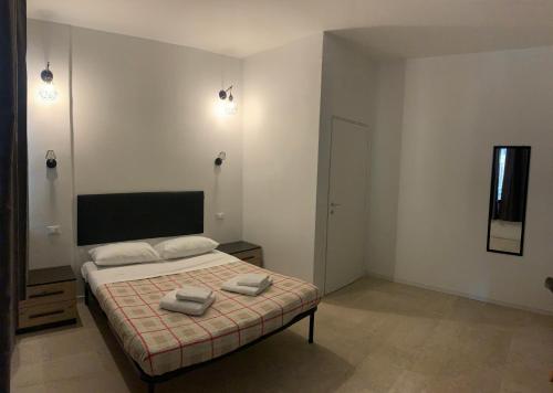 a bedroom with a bed with two towels on it at GALLERIA DEL TORO 3 rooms in Bologna