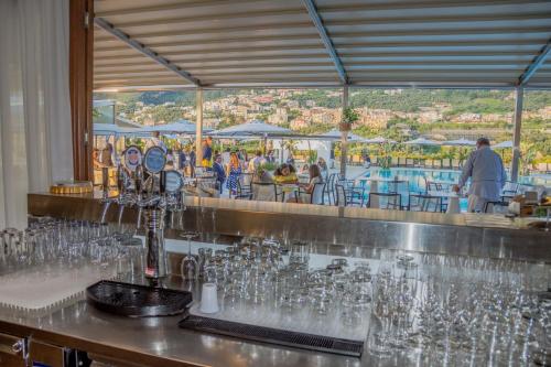 a bar with a bunch of glasses on a counter at Grand Hotel Moon Valley in Vico Equense