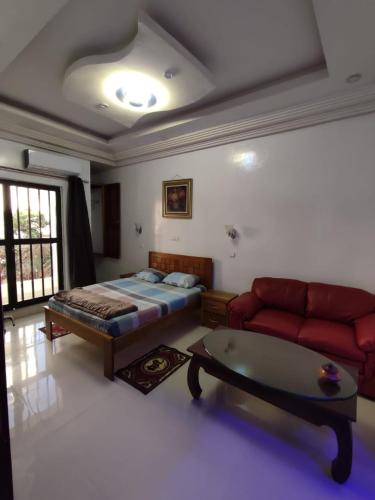a living room with a bed and a couch at Villa soleil du Sénégal in Dakar