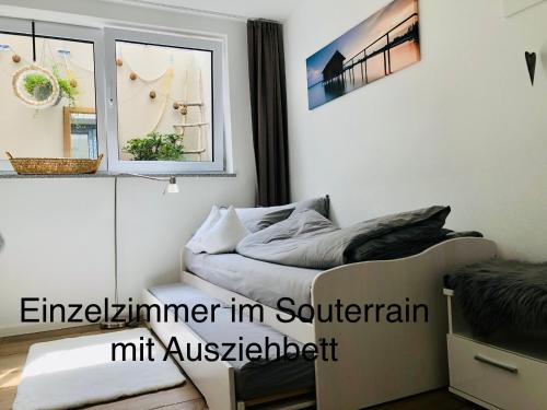 a bedroom with a bed and a window at Hirschzimmer & Strandzimmer in Utting am Ammersee