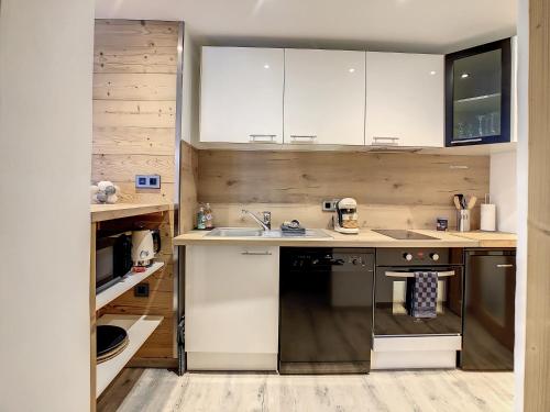 a kitchen with a sink and a dishwasher at Mont Alt, F2 40m2 en rdc, calme, Vue Mt Blanc in Passy