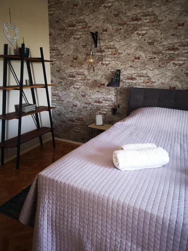 a bedroom with a bed with a white towel on it at Casa Segota in Veli Iž