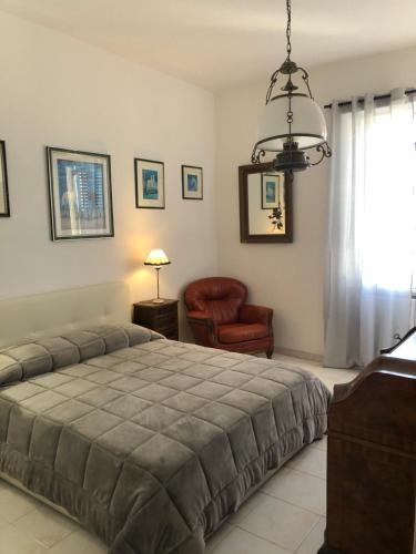 a bedroom with a bed and a lamp at B&B Maison Rosetta IUN-E4948 in Nuoro