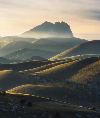 a mountain in the middle of a valley at IL BORGO DI ROCCA CALASCIO in Calascio