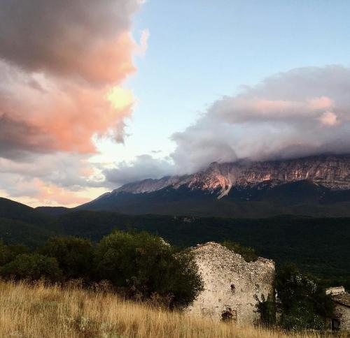 a view of a mountain with clouds in the sky at IL BORGO DI ROCCA CALASCIO in Calascio