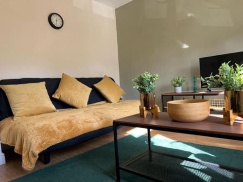 a living room with a couch and a table at Short term lets from £15 per person per night in Bristol
