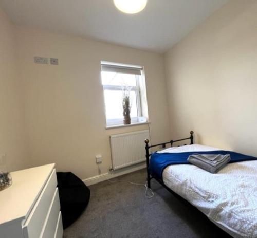 a bedroom with a bed and a window at Short term lets from £15 per person per night in Bristol