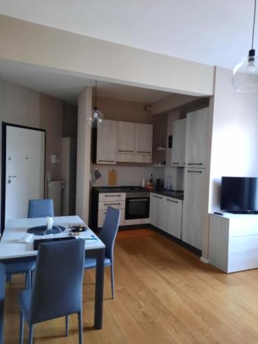 a kitchen with a table and chairs in a room at LUCIETTA 60 HOUSE in Florence