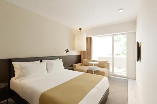 Un pat sau paturi într-o cameră la Hotel Cupidon