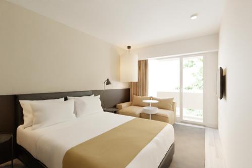 Postel nebo postele na pokoji v ubytování Hotel Cupidon