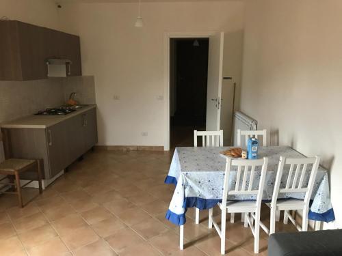 une cuisine avec une table et des chaises et une cuisine avec un comptoir dans l'établissement Kame house, à Castelbuono