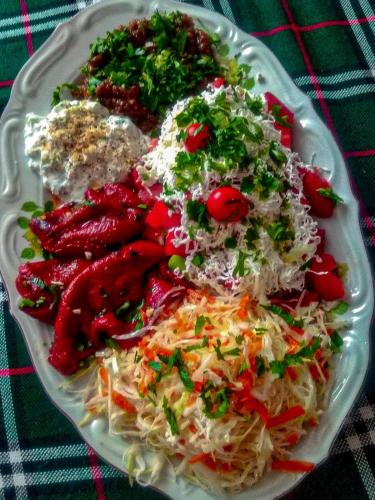 a plate of food with pasta and vegetables on a table at Семеен Хотел "При Мечо" in Rilski Manastir