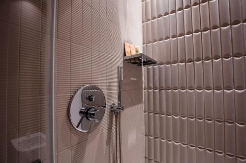 a shower in a bathroom with a mirror at La Corte del Fante in Marsala