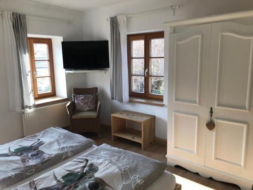 a bedroom with a bed and a flat screen tv at Landhaus Aigner in Allhartsberg