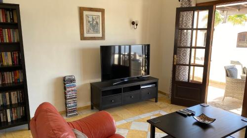 a living room with a television and a coffee table at Casa Sophia in Playa Blanca