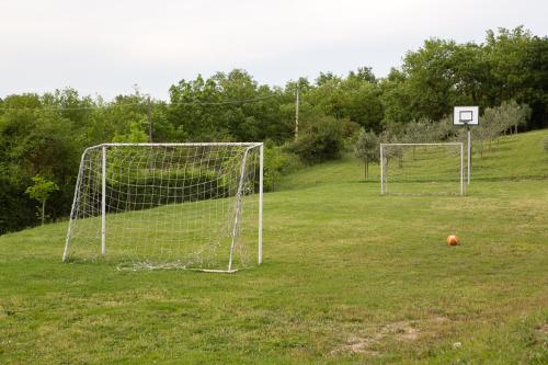 an empty field with a soccer goal and a ball at Podere Il Tigliolo in Castiglione dʼOrcia