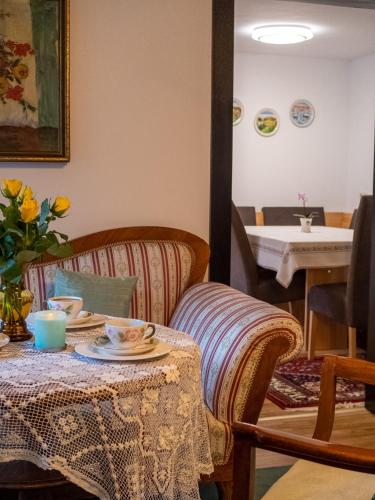 a table with cups and saucers on it at Katzerhaus Ebensee in Ebensee
