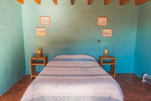 a bedroom with a bed and two night tables at Morros del Pacífico in Pichilemu