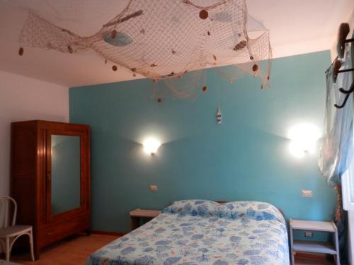 a bedroom with a bed and a blue wall at Calì B&B in Alatri
