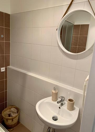 a bathroom with a sink and a mirror at Apartmán Luhačovice II. in Luhačovice