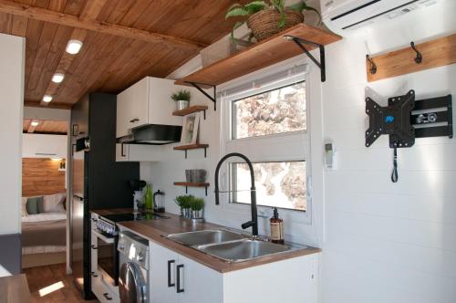 a kitchen with a sink in a tiny house at Chalets Didoche in Havre-Saint-Pierre