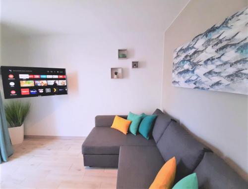 a living room with a couch and a painting at Casa Gil Corralejo San Valentin in Corralejo
