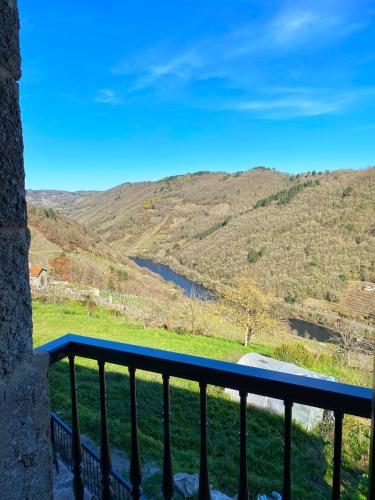 a view from a balcony of a river and mountains at Casa do Veiga in Chantada