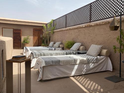 a group of beds sitting on a patio at Riad Djebel in Marrakesh