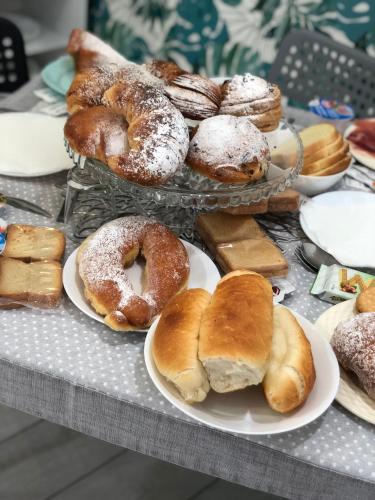 a bunch of different types of donuts and pastries on plates at Maison De luxe in Pompei