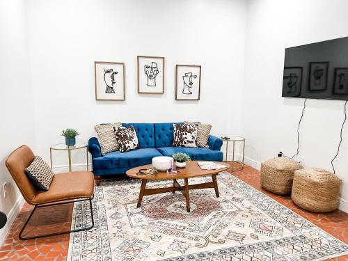 a living room with a blue couch and a table at Bon Maison Guest House in New Orleans