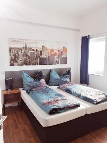 a bedroom with two beds and a picture on the wall at Motel Graz Ost I Free Parking I Self Check-in in Graz