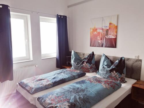 two beds sitting on a couch in a living room at Motel Graz Ost I Free Parking I Self Check-in in Graz