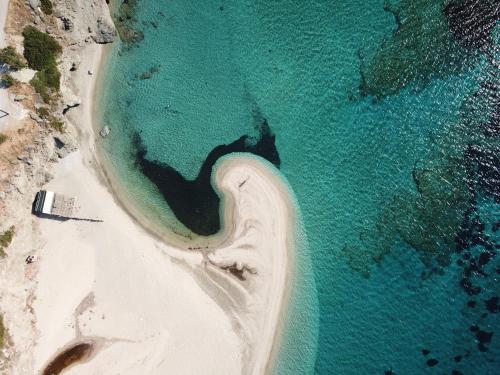 an aerial view of a beach with turquoise water at 3SSS Bouquet Studios SERENITY in Marmarion
