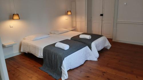 a bedroom with two beds with towels on them at A Casa do Tenente in Faro