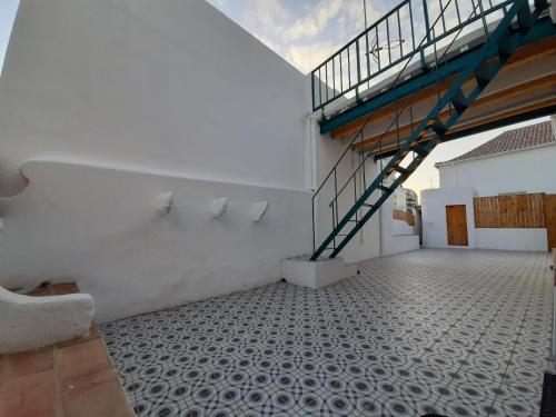 a room with a staircase on the side of a building at A Casa do Tenente in Faro
