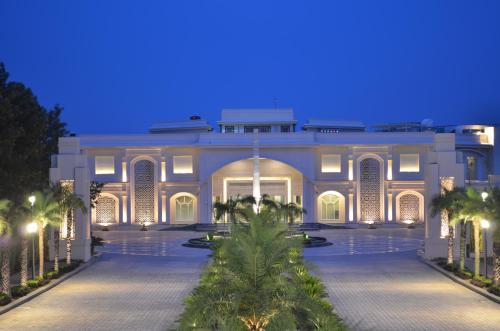 a large building with a courtyard at night at The Umrao in New Delhi