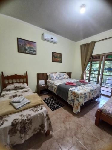 Cama ou camas em um quarto em Sítio Flora Rei