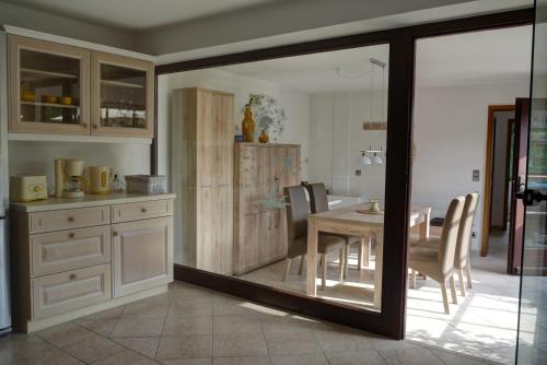 a kitchen with a table and a dining room at Haus Sonnenschein in Zingst