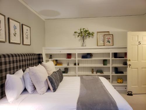 a bedroom with a large bed with white pillows at Hearthside Inn in Bar Harbor