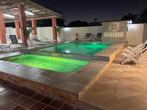 a swimming pool with green water in a building at Curasita Colour Appartments & Resort - adres kaya Sucre nst 282 in Willemstad