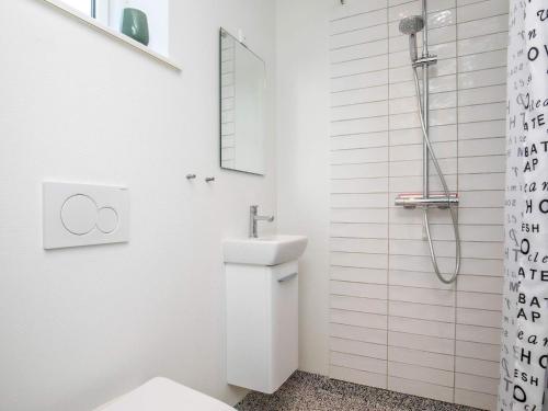 a white bathroom with a toilet and a sink at Holiday home Esbjerg V XX in Esbjerg