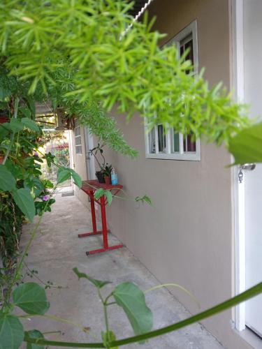 a red bench sitting in front of a building at Hostal Brisas Calobrenas in Calobre