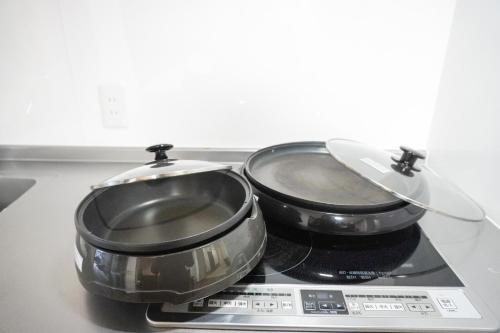 two pans sitting on top of a stove at Tiz 海岸通り in Sumoto